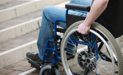 A young man in a wheelchair who can’t get up the stairs