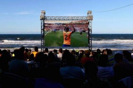 Fans watch the FIFA Confederations Cup, first semi final match between Brazil and Uruguay, on Praia Futuro on June 26, 2013 in Fortaleza, Brazil.