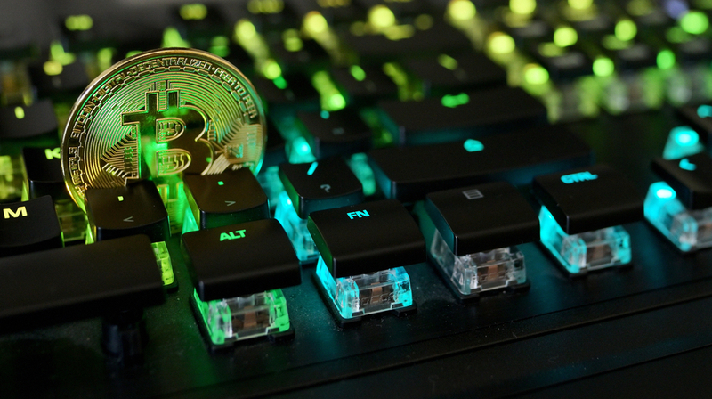 Galati, Romania – April 09, 2021 Studio shot of golden Bitcoin virtual currency on a computer keybopard