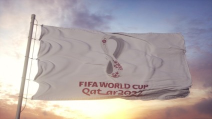 Doha, Qatar, February 2022: FIFA World Cup Qatar 2022 flag waving in the wind, blue sky background. 3d rendering.