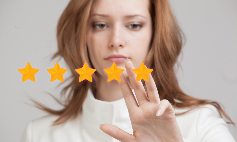 5 star rating or ranking, benchmarking concept on grey background. Woman assesses service, hotel or restaurant