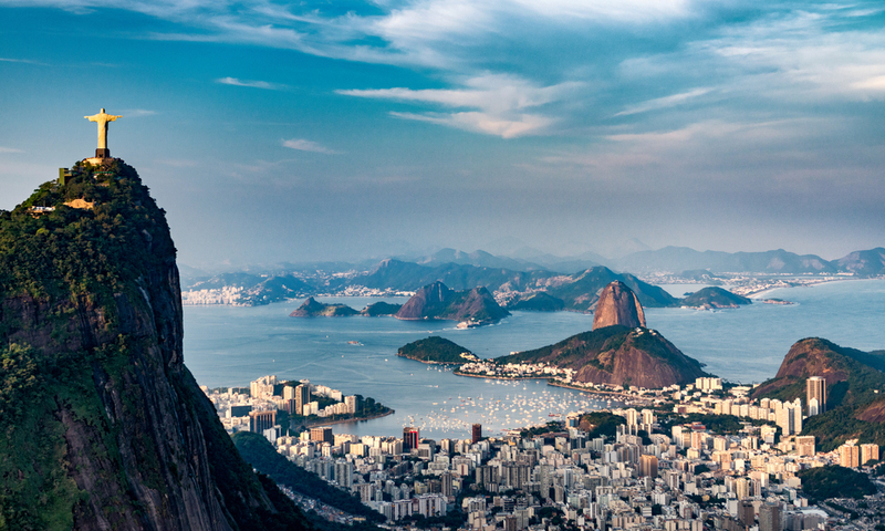 Aerial view of Rio De Janeiro. Corcovado mountain with statue of Christ the Redeemer, urban areas of Botafogo and Centro, Sugarloaf mountain.