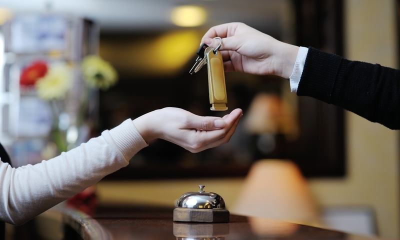 business woman at the reception of a hotel checking in