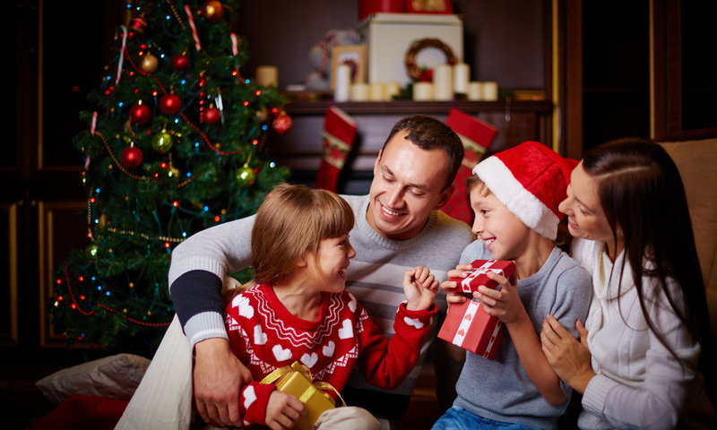 Joyful family having fun on Christmas evening at home