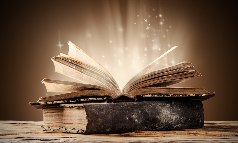 Old books on wooden planks with blur shimmer background