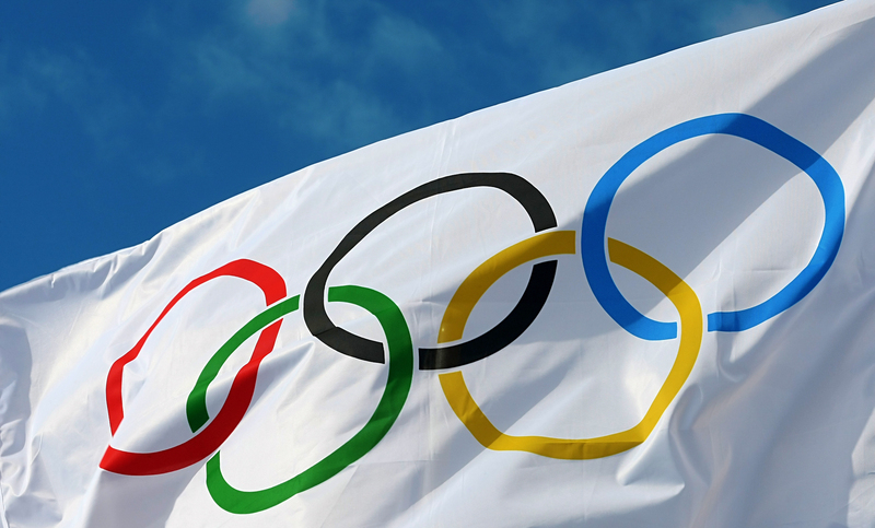 ATHENS, GREECE- OCTOBER 2, 2013: White Olympics Flag against the blue sky in Athens, Greece.