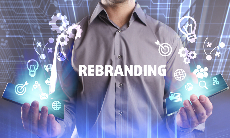 Business, Technology, Internet and network concept. Young businessman working on a virtual screen of the future and sees the inscription: Rebranding