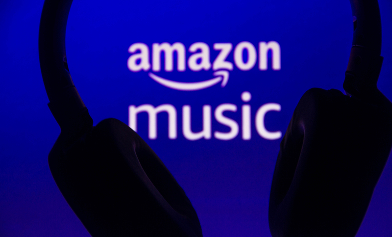 July 6, 2021, Brazil. In this photo illustration the Amazon Music logo is displayed along with the headset. It is a music streaming platform and online music store operated by Amazon