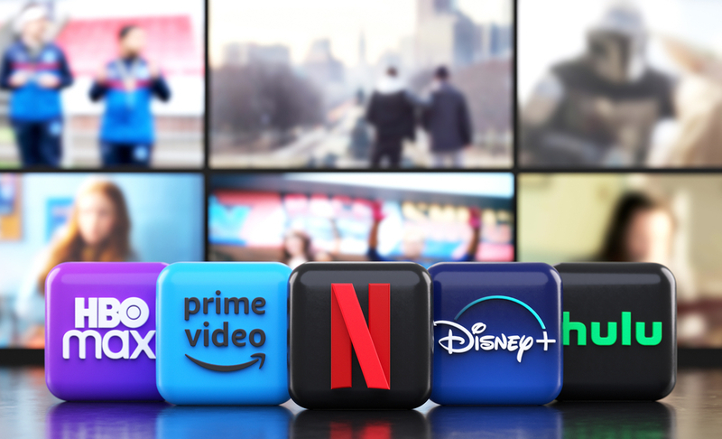 Valencia, Spain – March, 2023: App logos of the main providers of streaming movies and TV series in front of TV screens, icons in 3D illustration. Netflix, Prime Video, Disney Plus, Hulu and HBO Max