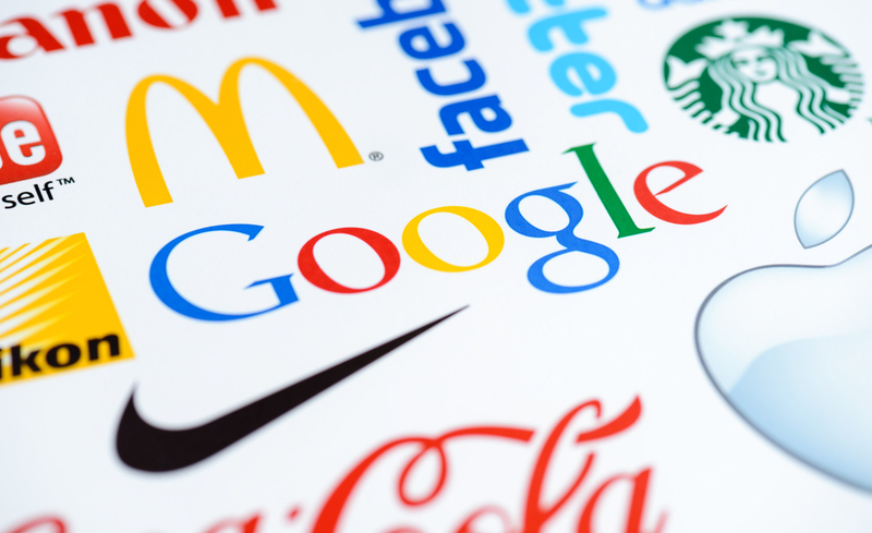 Kiev, Ukraine – June 27, 2012 – Close up photo of the Google logo on the printed paper together with a collection of well-known brands of the world.