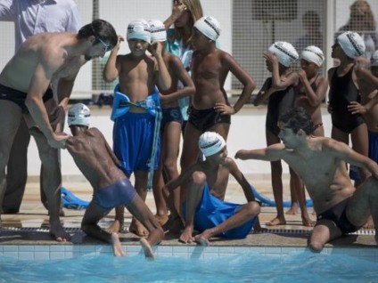 Michael Phelps nada com crianças da Rocinha