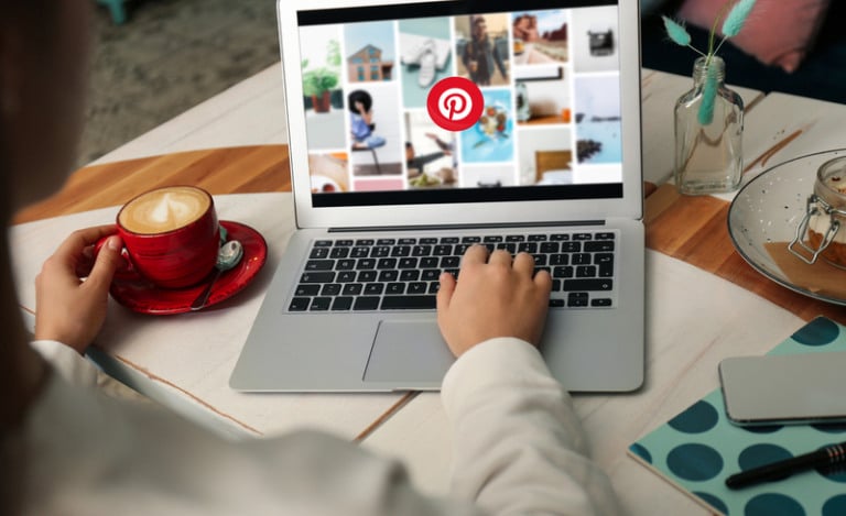MYKOLAIV, UKRAINE – MAY 4, 2020: Woman using Pinterest site on laptop indoors, closeup. Social media web