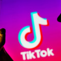 April 6, 2023, Brazil. In this photo illustration, a woman’s silhouette holds a smartphone with the TikTok logo in the background