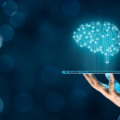 Artificial intelligence (AI), machine deep learning, data mining, and another modern computer technologies concepts. Brain representing artificial intelligence and businessman holding futuristic tablet.