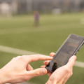 Man using online sports betting services on phone.