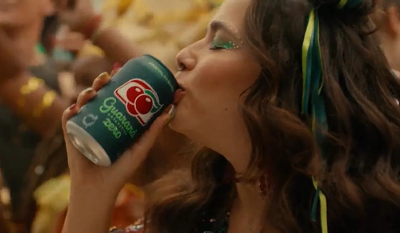 Imagem mostra mulher beijando uma lata de Guaraná Antártica, simbolizando a campanha "É Coisa Nossa"