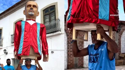 Boneco gigante em homenagem ao carregador Carlos da Burra com cores de Dorflex MAX